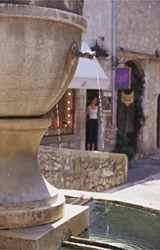 Village fountain and baker's store in Provence